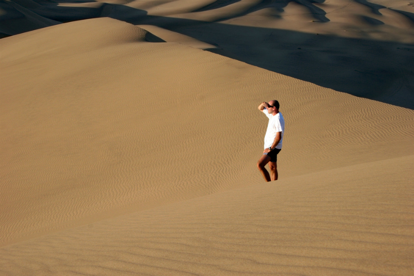 Man in sand dune, Namibia (Shutterstock)