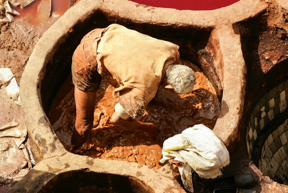 man working in tannery vat fez